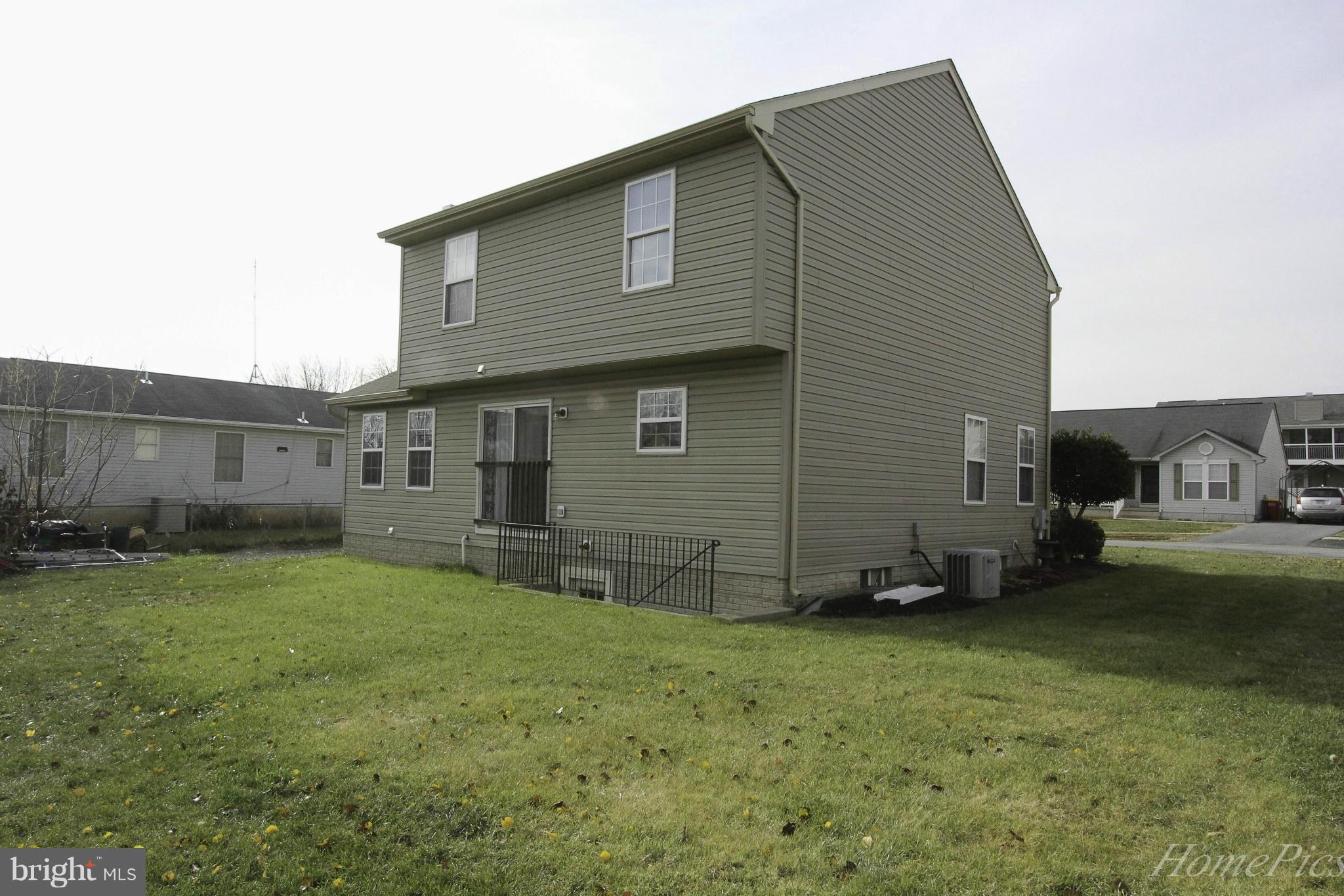 109 Limited Drive Ranson, WV 25438 - Photo 26 of 29 a front view of a house with a garden