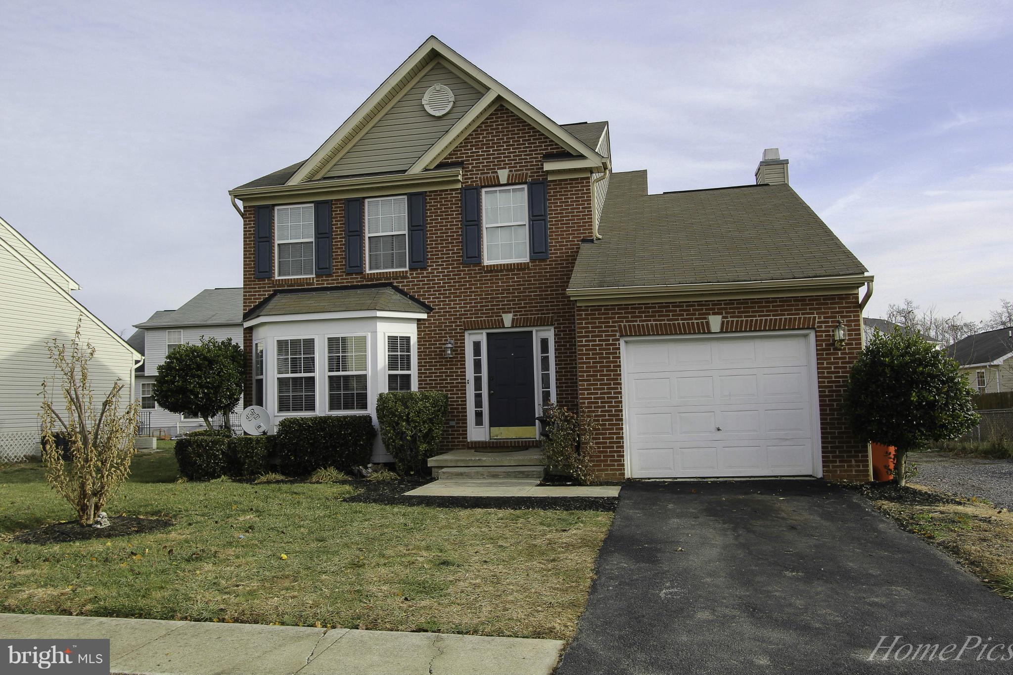 109 Limited Drive Ranson, WV 25438 - Photo 28 of 29 a front view of a house with a yard and garage
