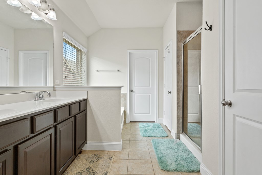 1916 Elaina Loop Leander, TX 78641 - Photo 15 of 23 a bathroom with a sink a mirror and a shower
