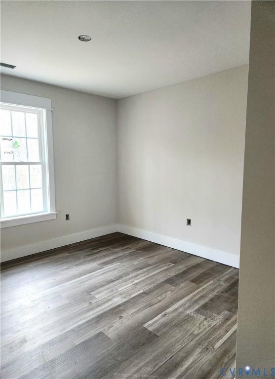 5081 Nomini Hall Road Hague, VA 22469 - Photo 14 of 21 an empty room with wooden floor and windows