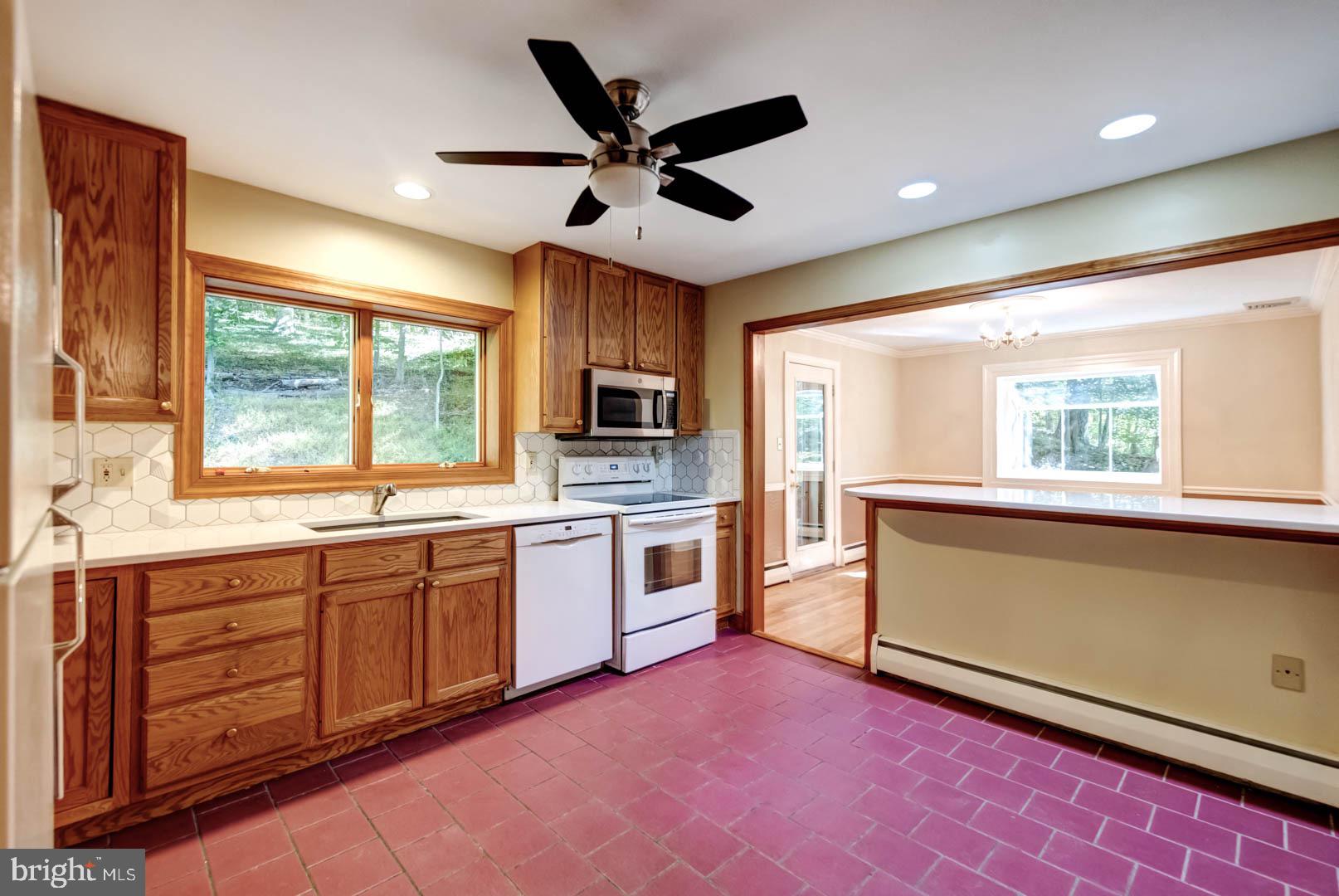 5 Walnut Lane Berwyn, PA 19312 - Photo 13 of 30 a open kitchen with granite countertop a stove top oven sink and window