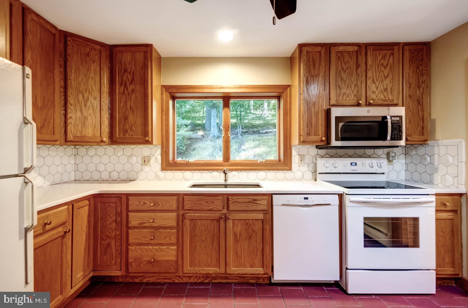 5 Walnut Lane Berwyn, PA 19312 - Photo 14 of 30 a kitchen with stainless steel appliances granite countertop a stove a sink and a microwave