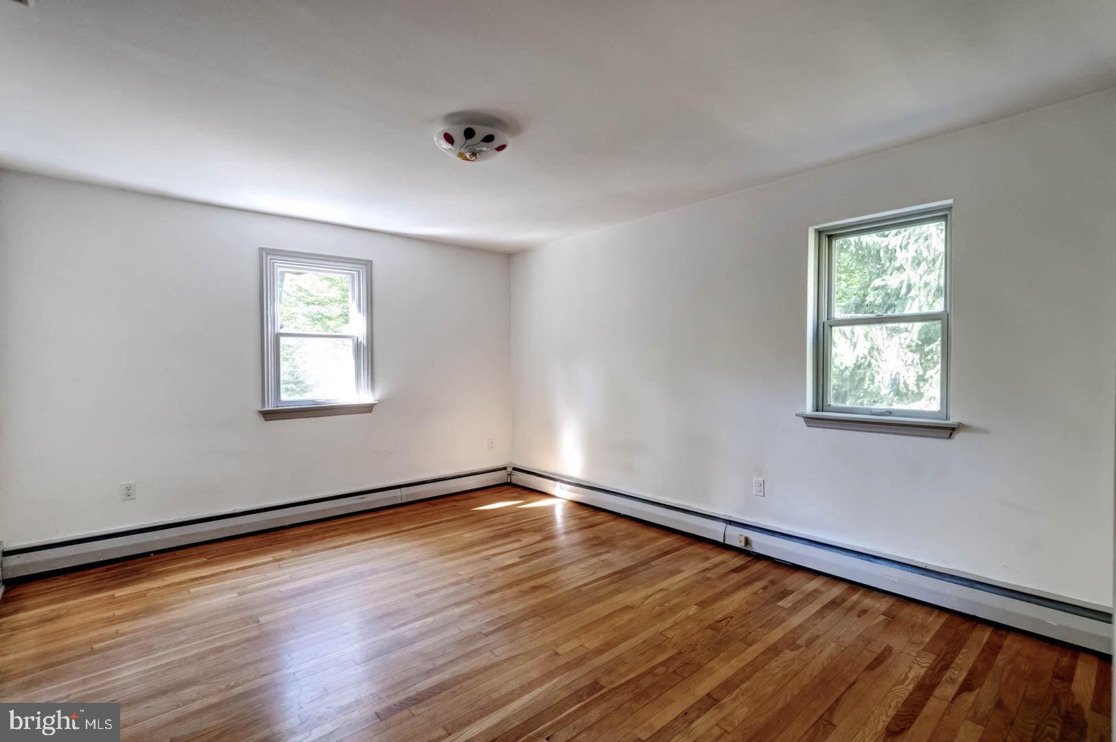 5 Walnut Lane Berwyn, PA 19312 - Photo 21 of 30 a view of an empty room with wooden floor and a window