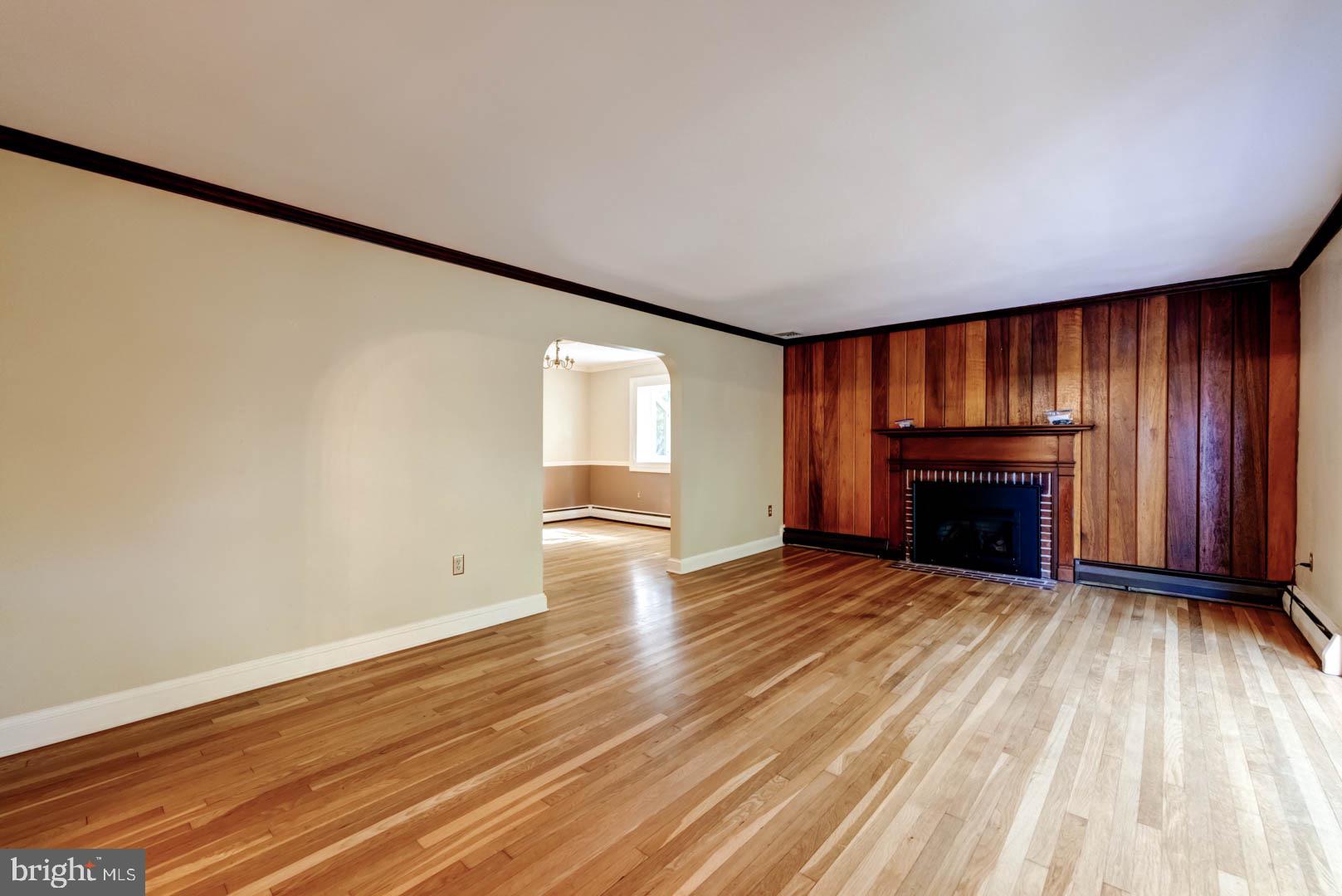 5 Walnut Lane Berwyn, PA 19312 - Photo 10 of 30 an empty room with wooden floor fireplace and windows