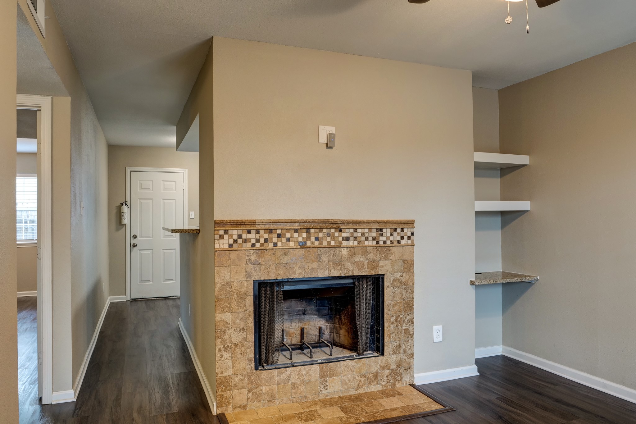 9020 Grannis Street, Unit 4 Houston, TX 77075 - Photo 6 of 8 a living room with a fireplace and wooden floor