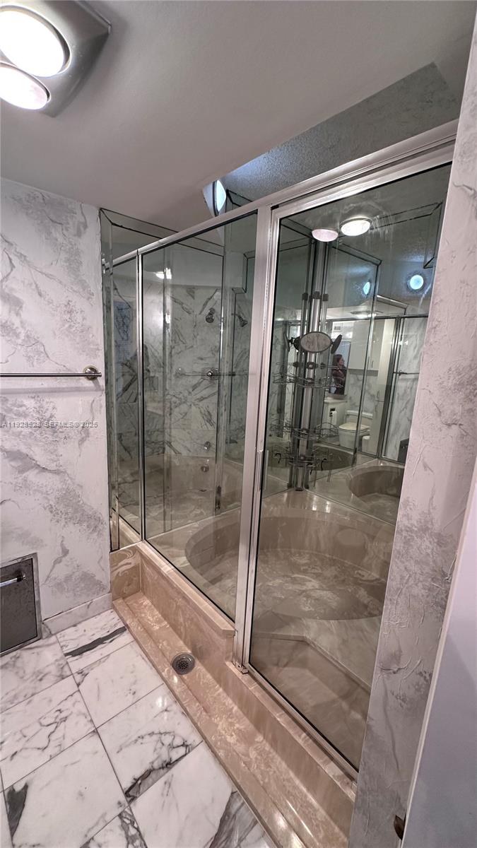 1865 Brickell Avenue, Unit A709 Miami, FL 33129 - Photo 18 of 19 a bathroom with a glass shower door