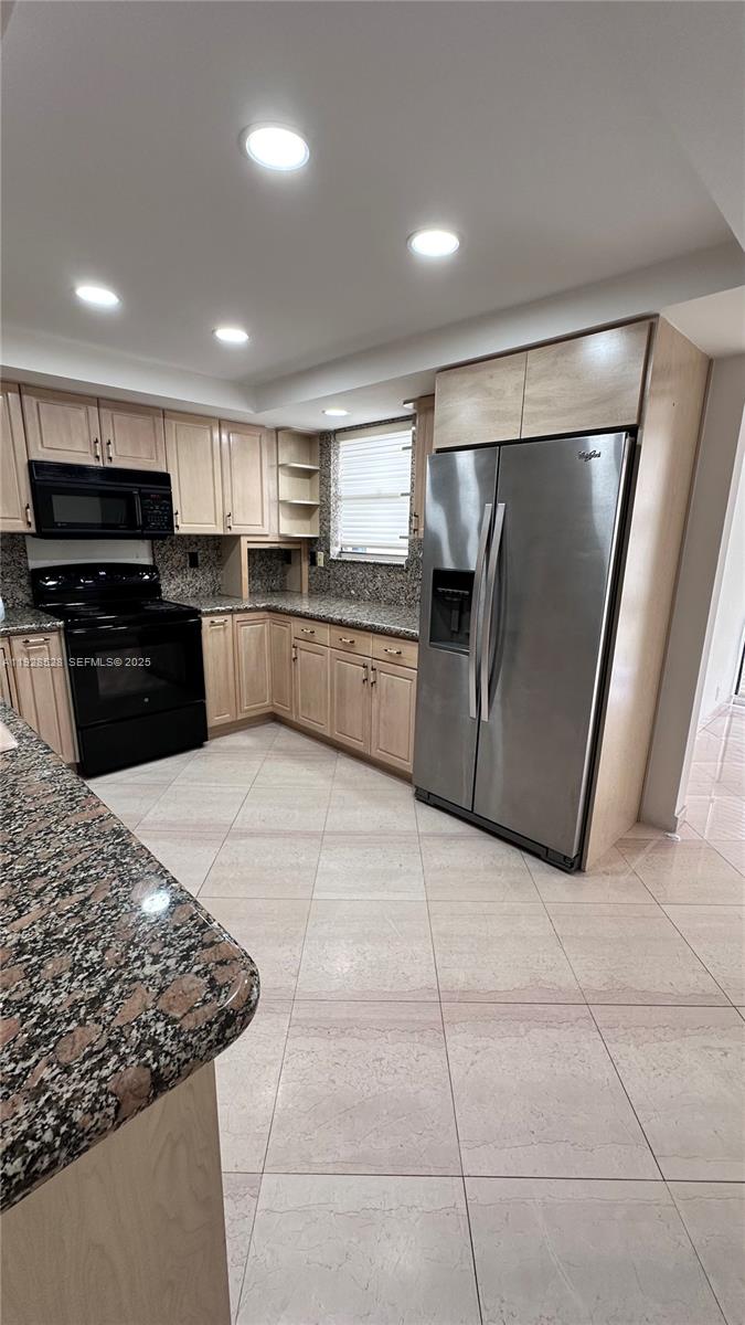 1865 Brickell Avenue, Unit A709 Miami, FL 33129 - Photo 6 of 19 a kitchen with stainless steel appliances granite countertop a refrigerator and a sink