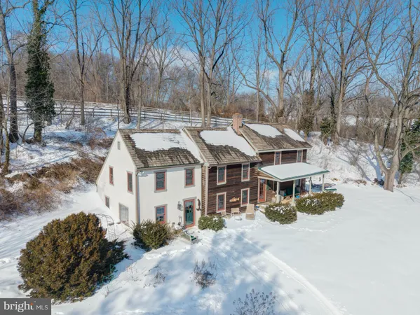 a front view of a house with a yard covered with snow in front of house