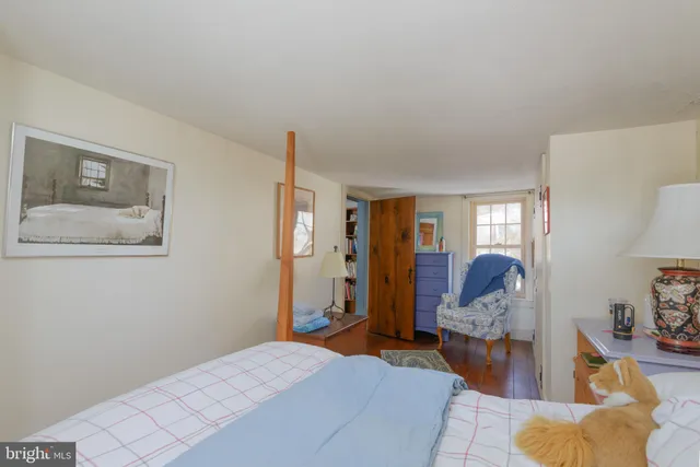 a bedroom with furniture and wooden floor