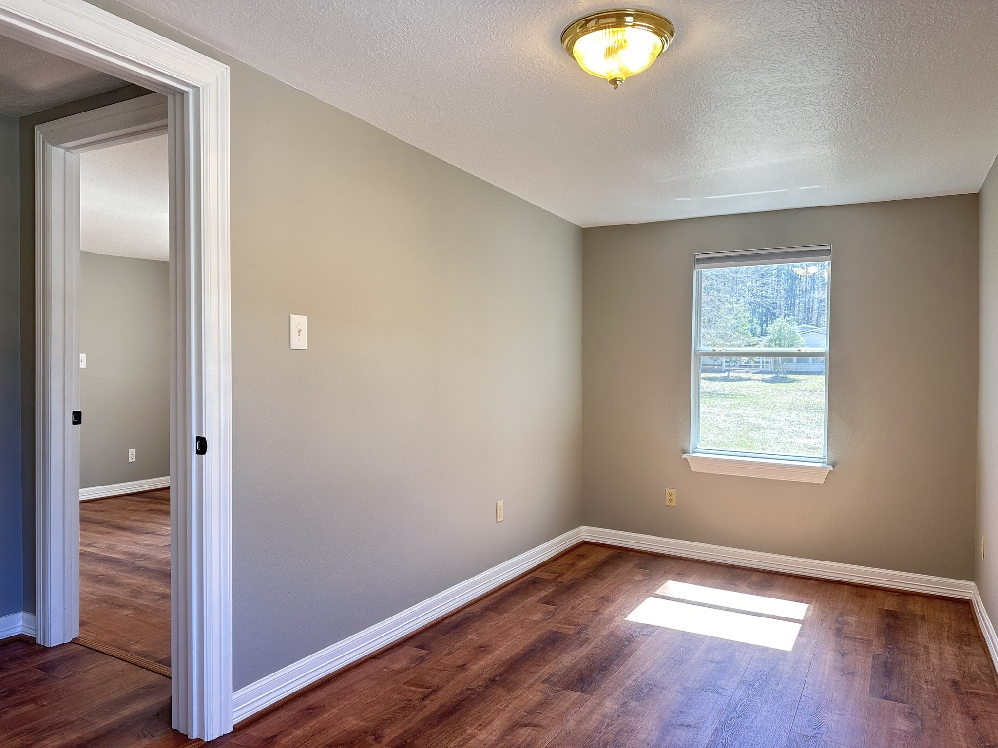 13868 Cedar Hill Road Montgomery, TX 77356 - Photo 7 of 19 a view of an empty room with wooden floor and a window