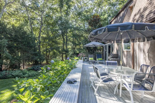 a view of patio with table and chairs under an umbrella
