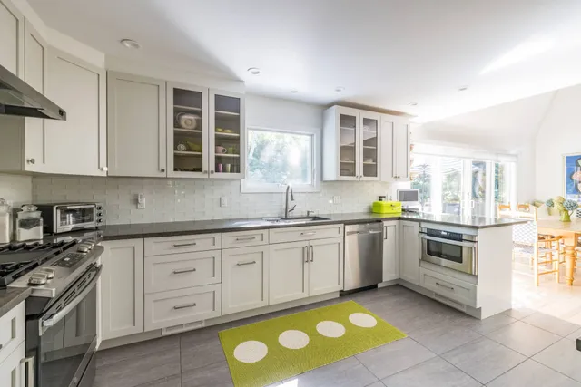 a kitchen with stainless steel appliances granite countertop a stove a sink and a granite counter tops