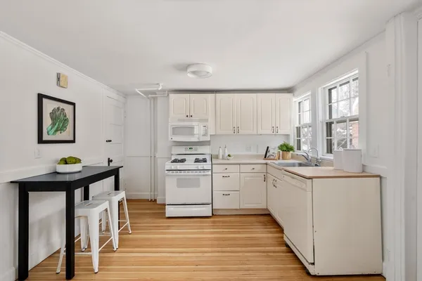 a kitchen with a stove a sink and a refrigerator