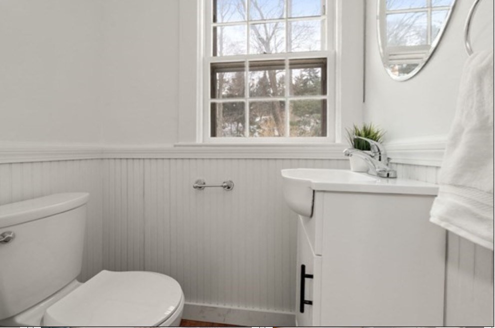 71 Highland Road, Unit 71 Brookline, MA 02445 - Photo 7 of 16 a bathroom with a sink a mirror and a toilet