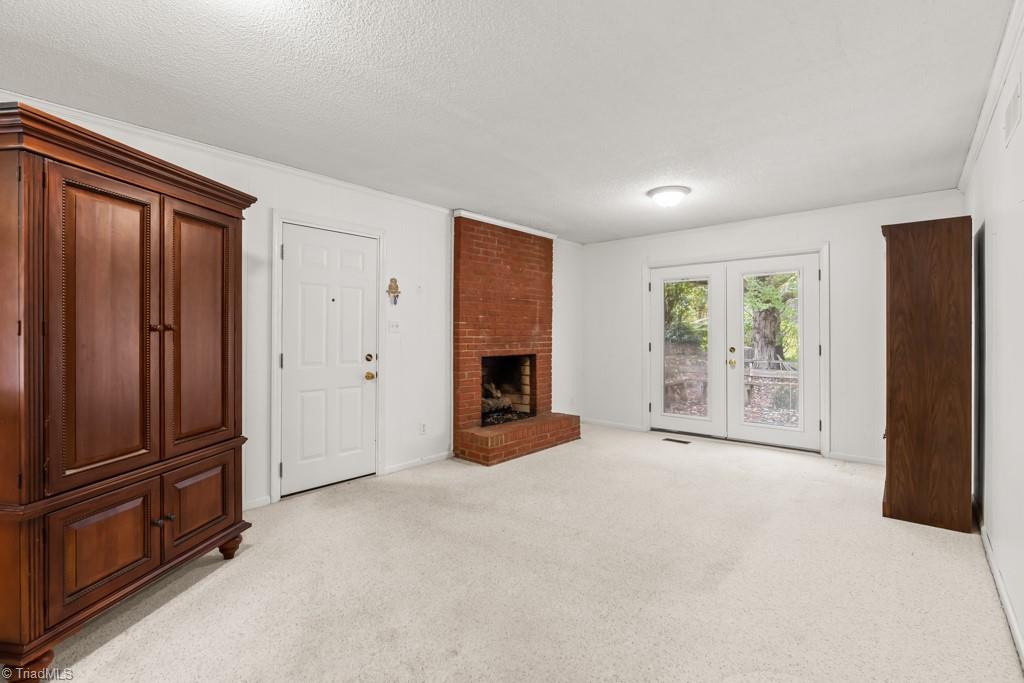 7001 Aplington Road Oak Ridge, NC 27310 - Photo 11 of 34 Cozy den which leads to carport & deck