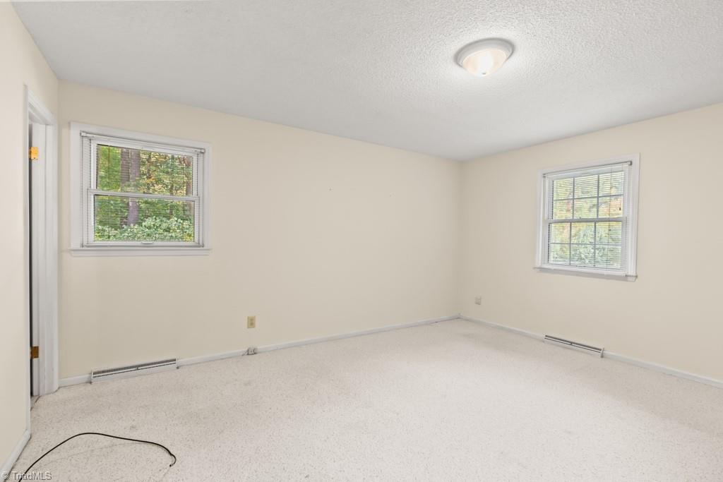 7001 Aplington Road Oak Ridge, NC 27310 - Photo 14 of 34 Spacious Primary Bedroom with full bath and cedar-lined closet