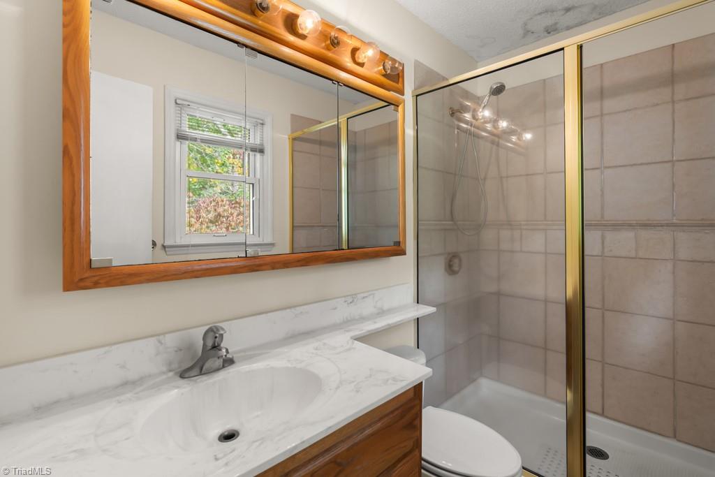 7001 Aplington Road Oak Ridge, NC 27310 - Photo 16 of 34 Primary Bath with tiled shower
