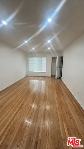 a view of an empty room and wooden floor