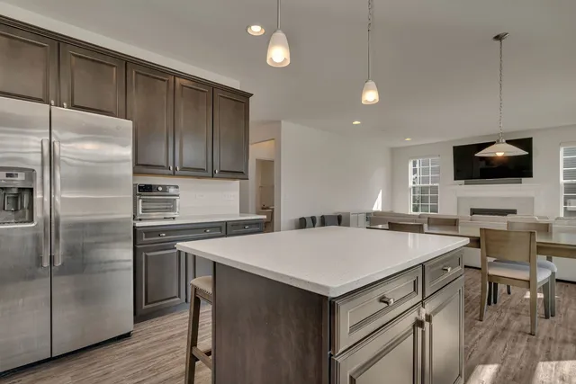 a kitchen with a stove a refrigerator and a microwave