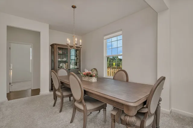 a view of a dining room with furniture and window