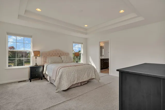 a spacious bedroom with a bed and a window