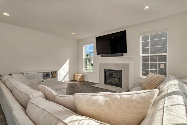 a living room with furniture a fireplace and a flat screen tv