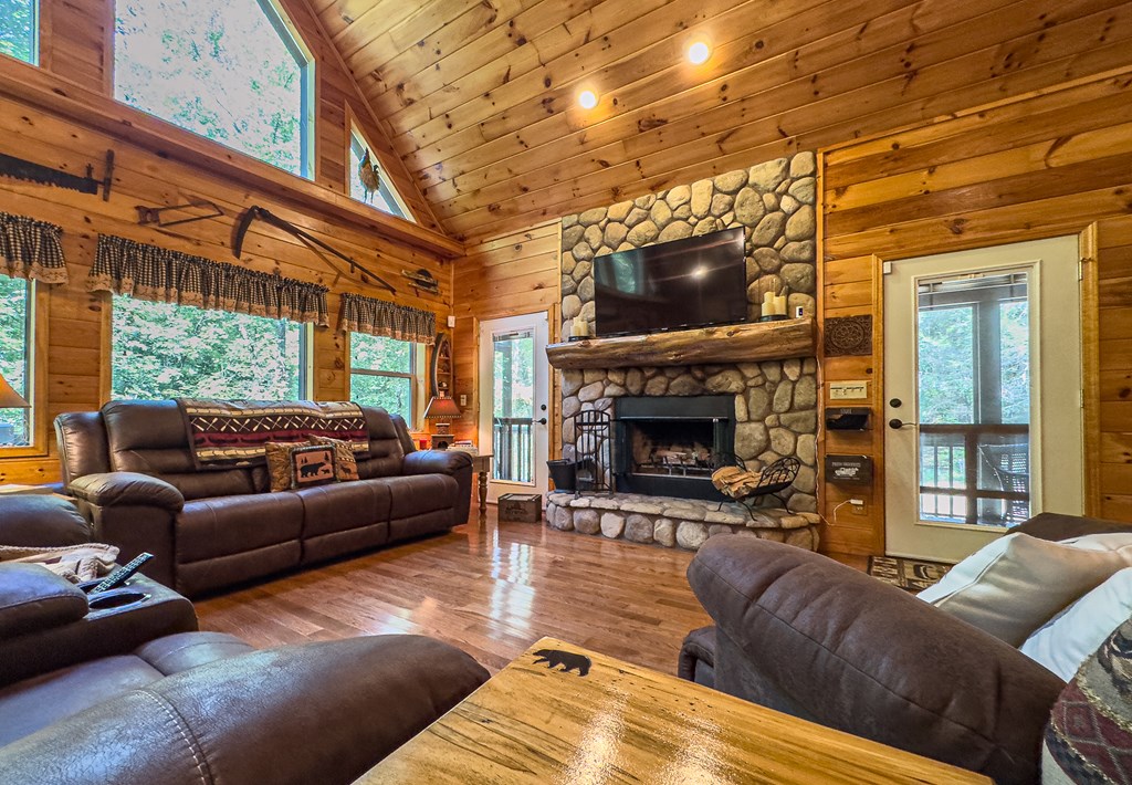 277 Virginia Lane Murphy, NC 28906 - Photo 11 of 62 a living room with furniture a fireplace and a flat screen tv