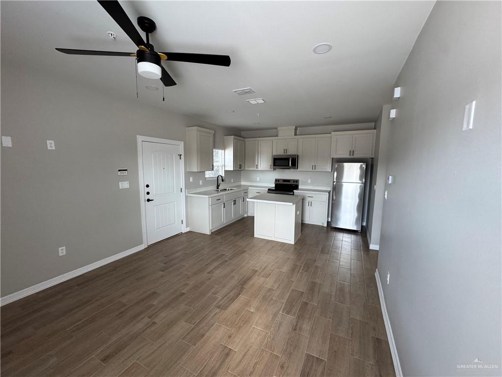 806 Ragland Road, Unit 1 Mission, TX 78572 - Photo 5 of 10 a view of kitchen with sink microwave and refrigerator