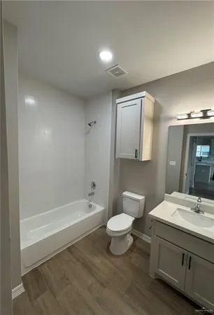 a bathroom with a sink a toilet and bathtub