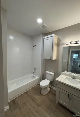 a bathroom with a sink a toilet and bathtub