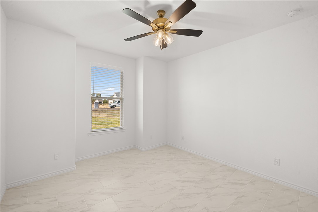 6512 Agave Court Bryan, TX 77808 - Photo 36 of 42 Empty room with light marble finish floors and ceiling fan