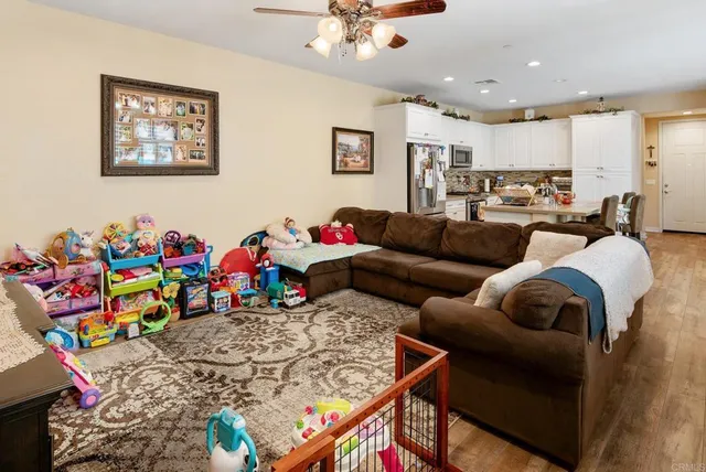 a living room with furniture and kitchen view