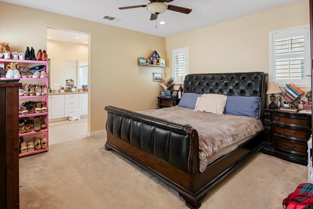 1158 Camino Prado Chula Vista, CA 91913 - Photo 16 of 25 a bedroom with a bed and a walk in closet