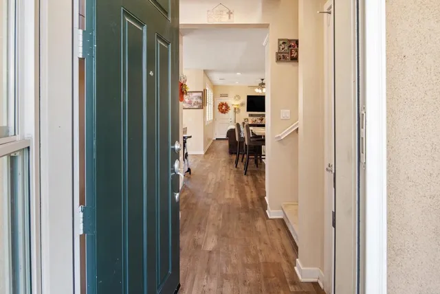 a view of a hallway with wooden floor windows