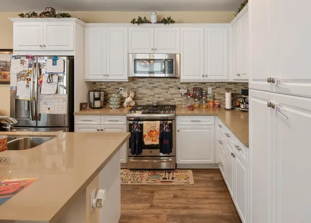 a kitchen with stainless steel appliances granite countertop a stove and a sink