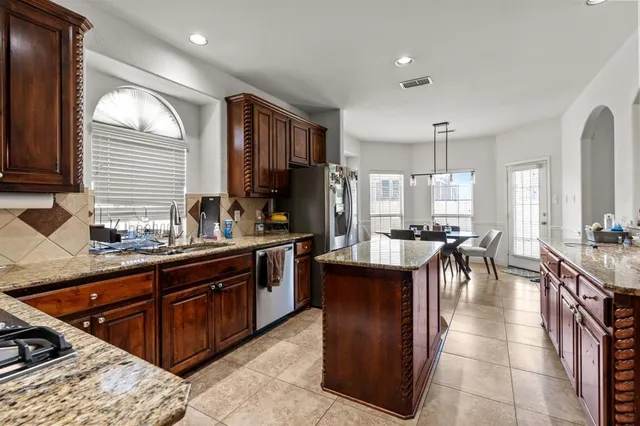 a kitchen with a stove and a living room