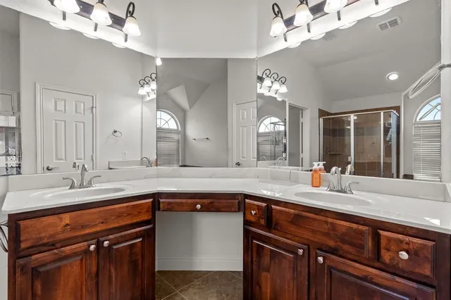 a spacious bathroom with a tub sink and a mirror