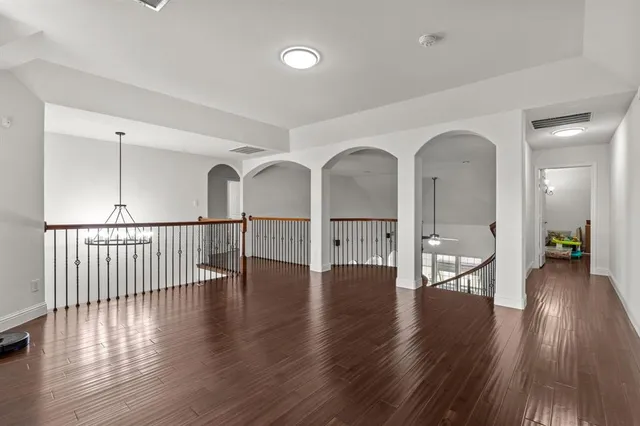 a bedroom with a bed and a ceiling fan