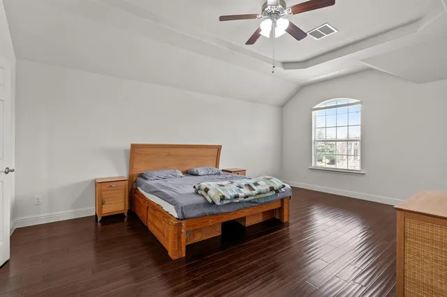 a room with gym equipment and a wooden floor