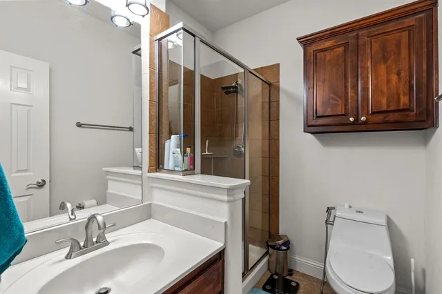 a white bed sitting in a living room next to a window