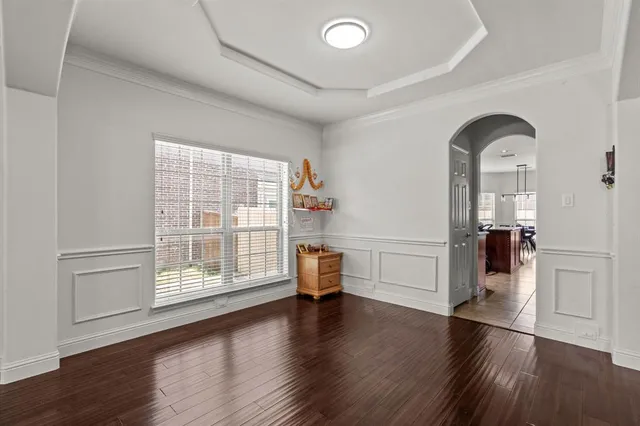 a view of empty room with a window and wooden floor