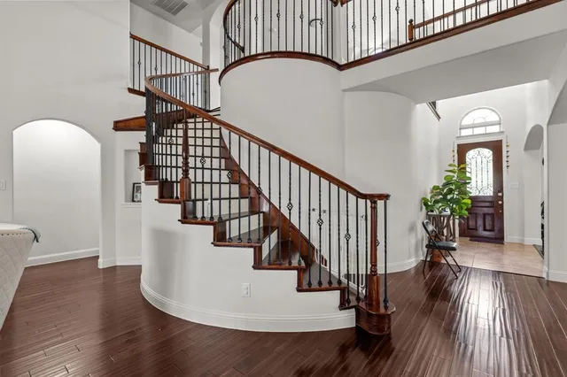 a view of entryway and hall with wooden floor