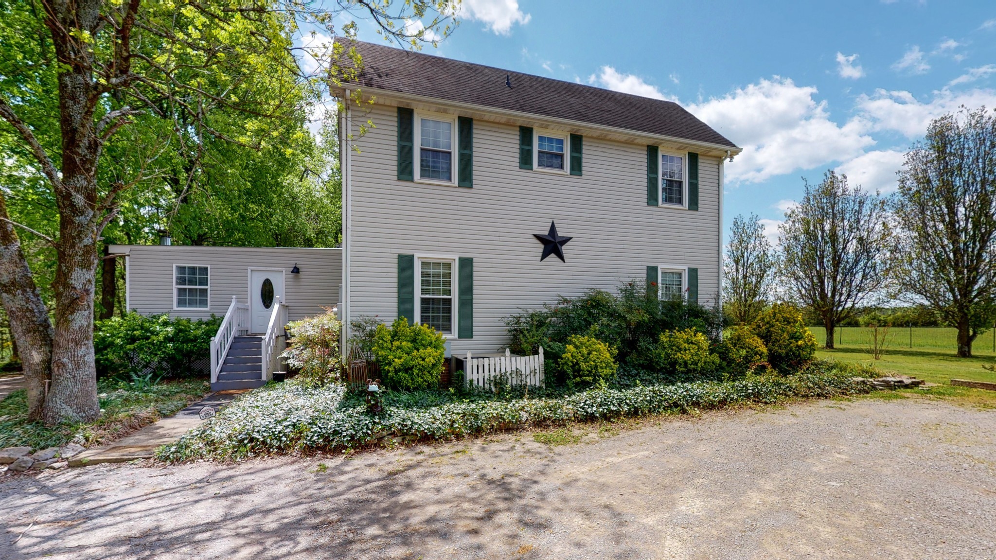 411 Squire Hall Road Bell Buckle, TN 37020 - Photo 36 of 50 a front view of a house with garden