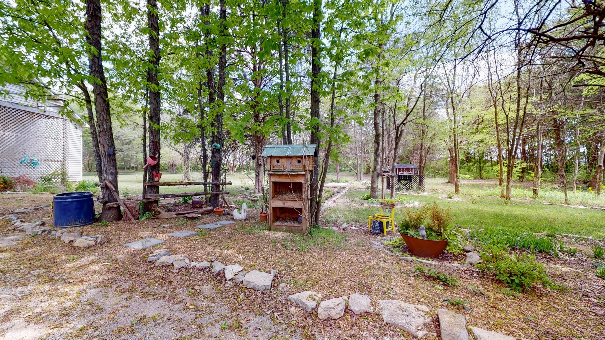 411 Squire Hall Road Bell Buckle, TN 37020 - Photo 45 of 50 a view of a backyard with large trees and a barn