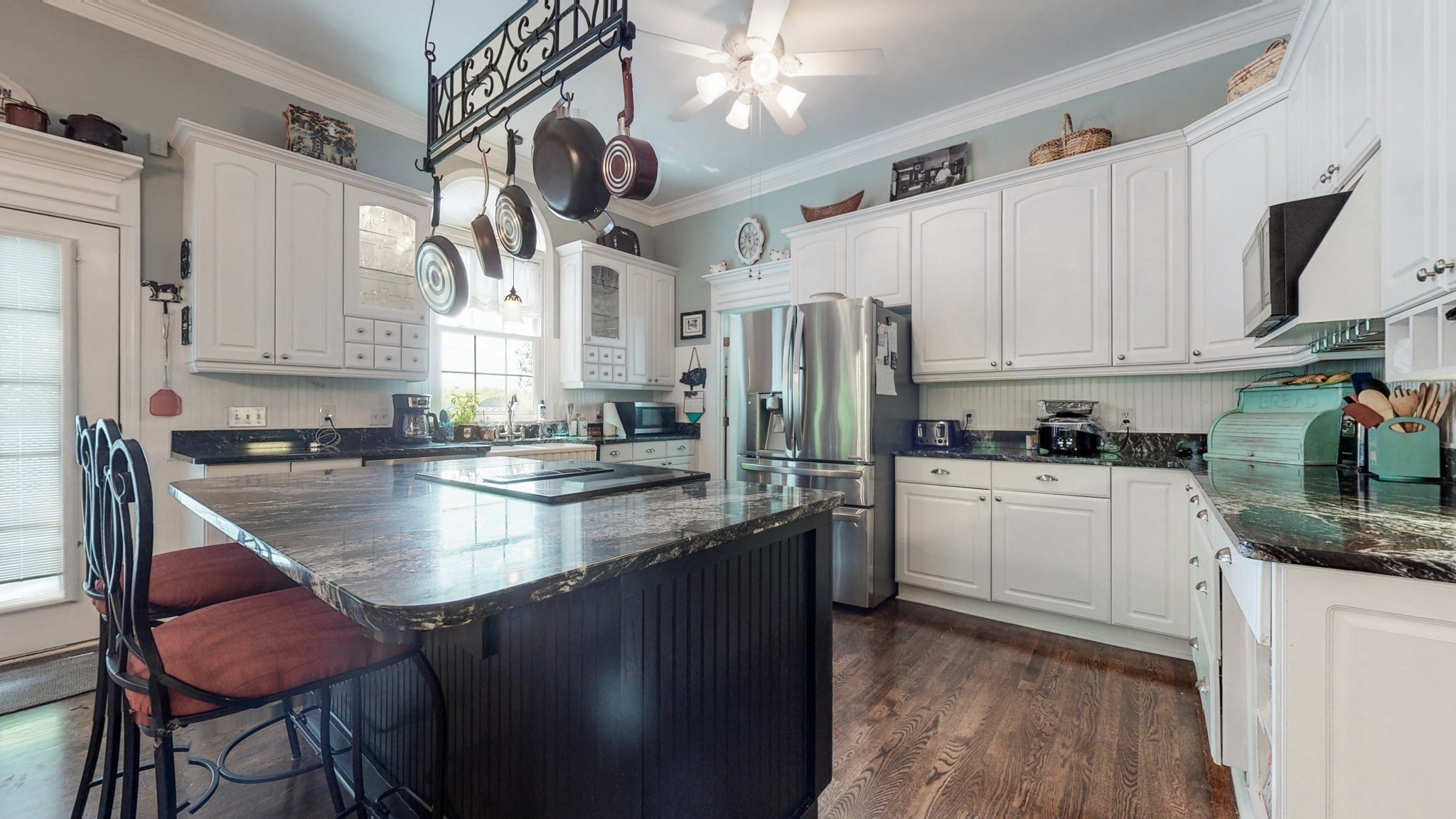 411 Squire Hall Road Bell Buckle, TN 37020 - Photo 10 of 50 a kitchen with stainless steel appliances granite countertop a sink a stove a refrigerator cabinets and chairs