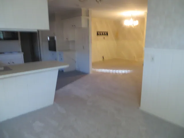 a view of a hallway with a chandelier