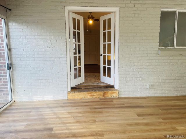 a view of a bedroom with wooden floor and door