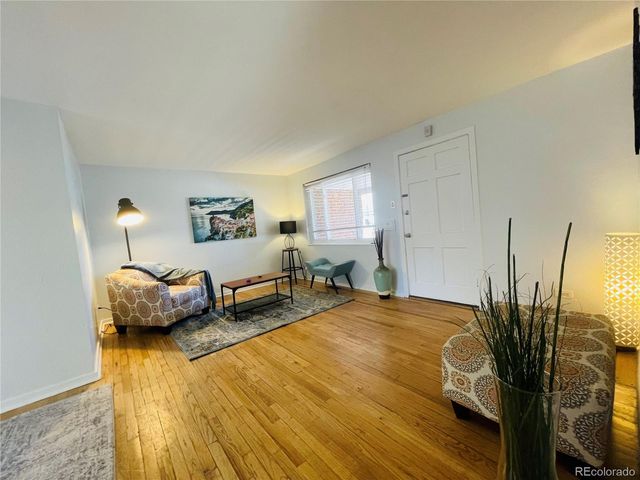a bedroom with furniture and a wooden floor