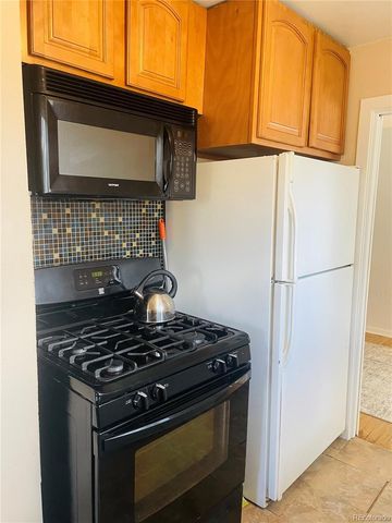 a stove top oven sitting inside of a kitchen