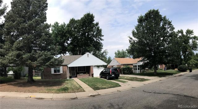 a front view of a house with a yard and table and chairs